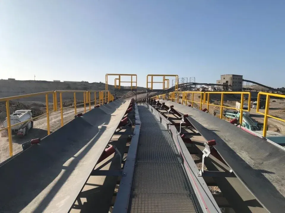 Conveyor line with service walkway and yellow railings