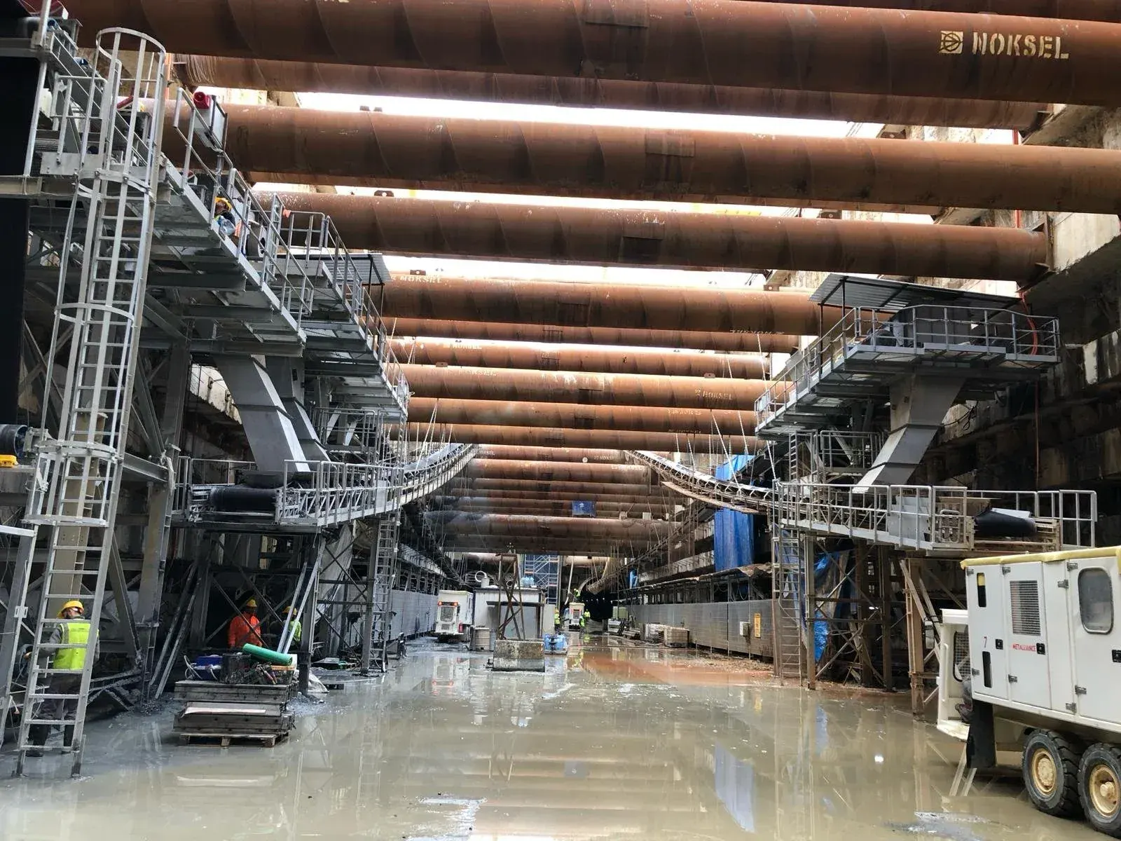 Steel platforms and stairways of tunnelling equipment inside a cavern